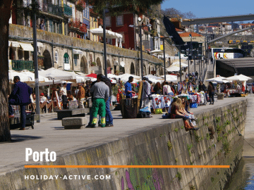 People sitting in the sun at Ribeira in Porto